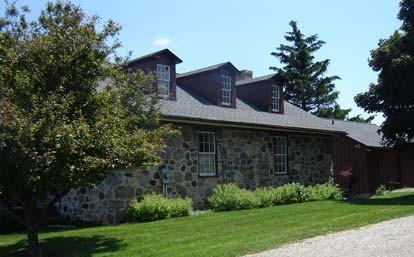 Of note are the dormer windows and fieldstone construction.; Kendra Green, 2007.
