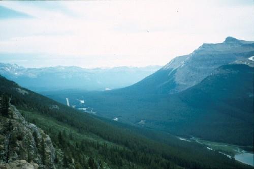 View of the final section of Kicking Horse Pass, showing the flanking mountains and the Spiral Tunnels, 1969.; Agence Parcs Canada / Parks Canada Agency, 1969.