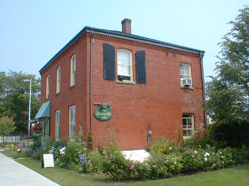 This image shows an angled view of the front façade and a side elevation, looking east, 2007.; Province of New Brunswick