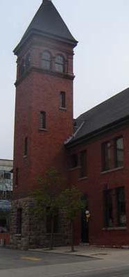 Featured is the four-storey pyramidal-roofed tower with paired arcaded windows.; Kendra Green, 2007.
