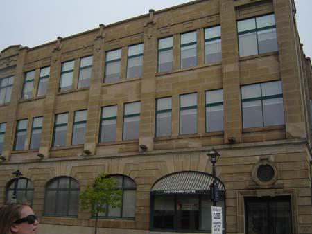 Of note are the panels of windows created by the projecting pillars on the second and third storeys.; Kendra Green, 2007.