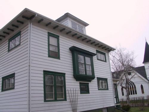 Showing oriel window and modillions in eaves; Wyatt Heritage Properties, 2003
