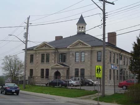 Featured is the symmetrical stone façade with hipped roof and bracketed wooden cornice.; Kayla Jonas, 2007.