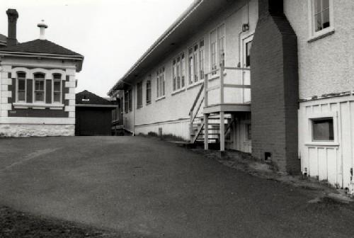 Western view of Building 37, showing the building’s relationship to Building 39, 1989.; Ian Doull, Parks Canada Agency / Agence Parcs Canada, 1989.