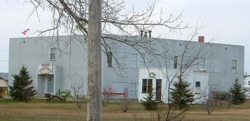 View of the Grounds of  Wakaw Elementary School featuring the Law Office Building and the 1949 School.; Winkel, 2007.