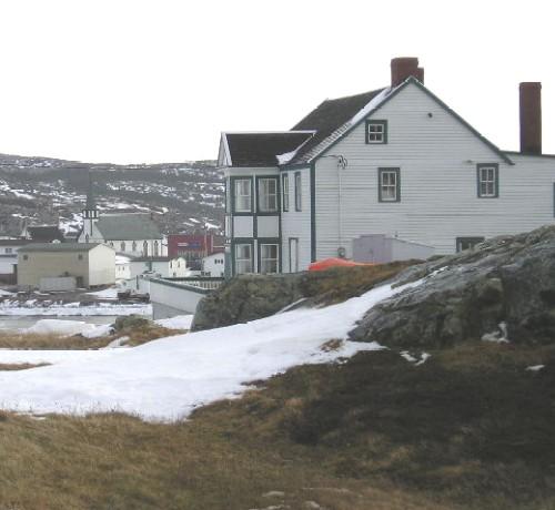 Right side view of Bleak House, Fogo, NL, circa 2005, with part of the bay and Main Street, including Our Lady of Snows Church, in the background; Town of Fogo, 2008