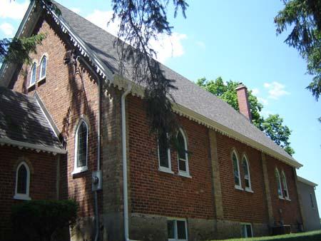 Of note are the steeply-pitched roofline and detailing on the eaves.; Kendra Green, 2007.
