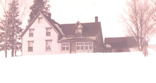 Showing east elevation; Archival image of house in winter