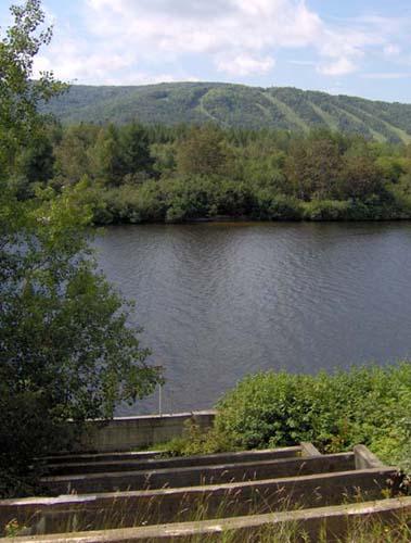 This photo shows the site of the sluice, facing Mont Farlagne, located on the opposite side of the Madawaska River; Madawaska Historical Society