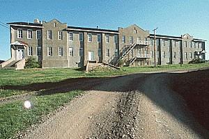 General view of Building 19, showing the exterior metal staircases, circa 2004.; Parks Canada Agency / Agence Parcs Canada, circa/vers 2004.