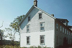 View of Building 39, showing the wood frame construction with a gabled roof, circa 2004.; Agence Parcs Canada / Parks Canada Agency, vers / circa 2004.