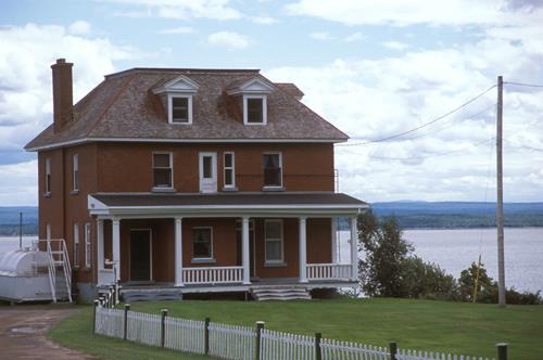View of Building 67, showing the two-and-a-half-storey, cubic-shaped massing with truncated hipped roof, circa 2004.; Agence Parcs Canada / Parks Canada Agency, circa / vers 2004.