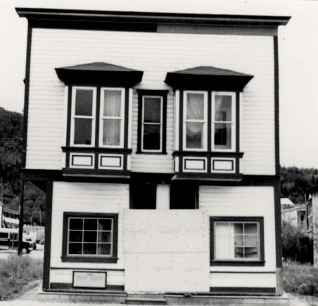 General view of Ruby's Place, showing the two-storey form and massing of the gable-roofed, symmetrical, false-fronted structure, 1987.; Parks Canada Agency / Agence Parcs Canada, 1987.