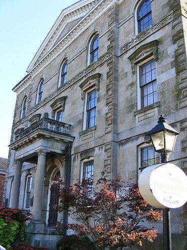 Detail view of Niagara District Court House, showing classical details, such as the corner quoins, pediment, stringcourses, and porch with columns, 2010.; Old Niagara Court House, Sean Marshall, October 2010.