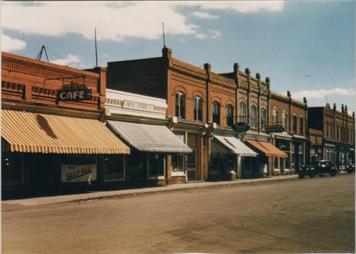 Archival view, from the northwest, of the Pharmacy Building (with white awning), Carberry, ca. 1940; Carberry Plains Archives, ca. 1940