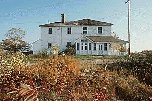 Façade of Building 38, showing the regular placement of the doors and the four pane windows, circa 2004.; Parks Canada Agency / Agence Parcs Canada, circa / vers 2004.