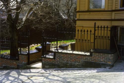 View of wrought iron fence that surrounds Howard House property. Photo taken during restoration, circa late 1980s.; HFNL 2007