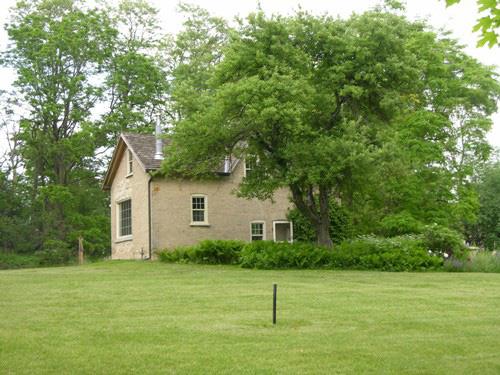 The Coach House on the Homer Watson House property showing some of the English-style garden -- 2006; OHT, 2006