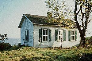 General view of Building 66, showing the small, single-storey massing with gable roof and chimney, circa 2004.; Parks Canada Agency / Agence Parcs Canada, circa/vers 2004.