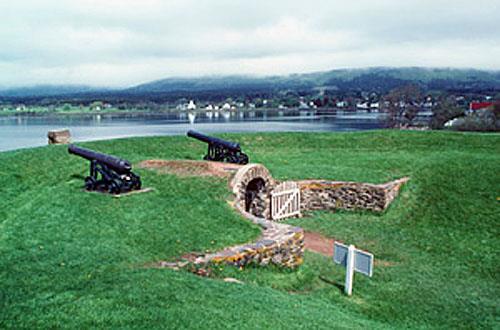 General view of the Black Hole Powder Magazine showing the mounded earth cover and the curved revetment walls of rubble stone, 1994.; Parks Canada Agency / Agence Parcs Canada, J.P. Jérôme, 1994.