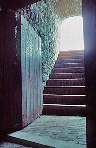 Interior view of the Black Hole Powder Magazine showing the vaulted bomb-proof construction of the passageway, 1994.; Parks Canada Agency / Agence Parcs Canada, J.P. Jérôme, 1994.