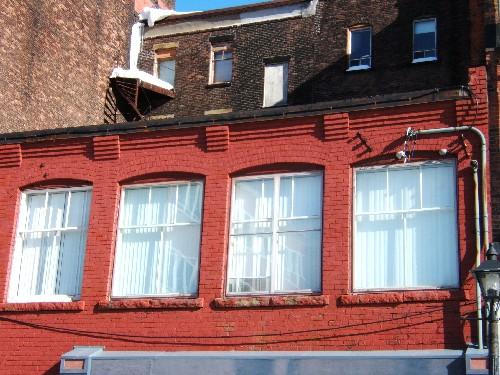 This photograph shows the upper storey windows and the roof-line cornice, 2005; City of Saint John