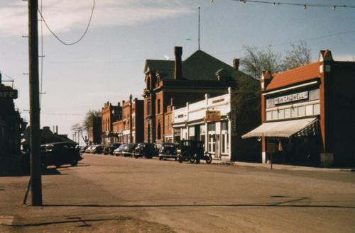 Archival view, from the northeast, of the Charlie Sear Building (last tall building in the row), Carberry, ca. 1945; Carberry Plains Archives, ca. 1945