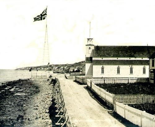 Historic image of the original John Guy flagstaff. The present day flag and pole are located on the same site. Photo taken circa 1910.; Town of Cupids 2008