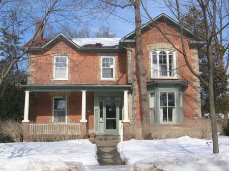 This photo features the verandah supported by columns and the gabled roof, 2007.; Lindsay Benjamin, 2007.