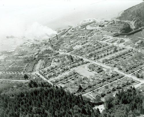 View of the Powell River Historic District, showing the compact placement of housing on the plan, and their spatial relationship to each other, 1956.; PRA, neg. 14110, May 1956
