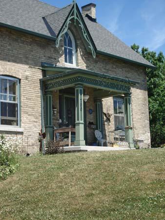 Of note is the lancet window and decorative bargeboard on the gable.; Kendra Green, 2007.