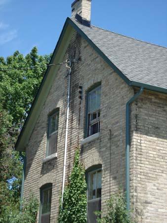 Of note are the 2 over 2 windows and chimney on the west elevation.; Kendra Green, 2007.