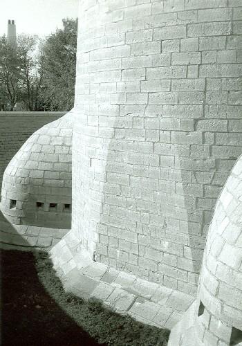 South side of Murney Martello Tower, showing the caponiers projecting into the ditch created by the encircling grassed berm, 1991.; Parks Canada Agency / Agence Parcs Canada, Fern Graham, 1991.
