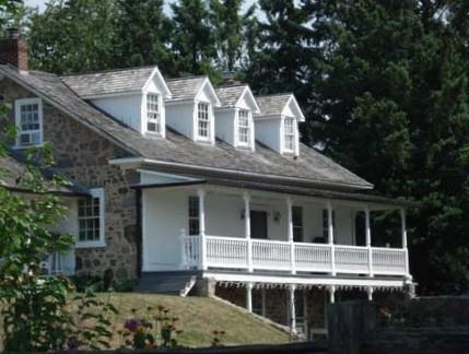 Of note is the exposed two-storey stone basement with plaster verandah.; Kendra Green, 2007.