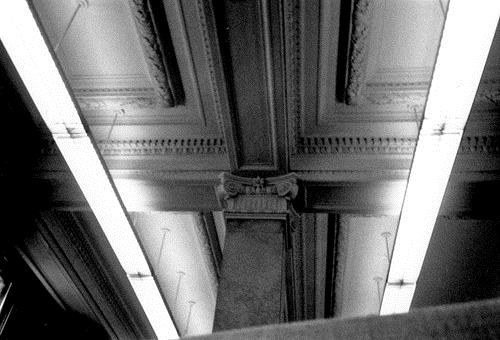 Interior view of Postal Station H, showing the square pillars capped by elaborate Ionic capitals and the coffered ceiling, 1990.; Parks Canada Agency / Agence Parcs Canada, S. Ricketts, 1990.