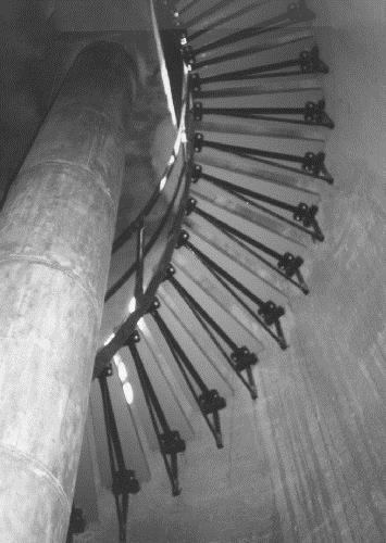Interior view of the Light Tower, showing the spiral stairway which provides access to each level and to the lantern, 1990.; Parks Canada Agency / Agence Parcs Canada, 1990.