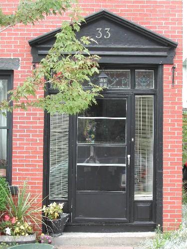 This photograph shows the entranceway with sidelights, transom window and pediment, 2005; City of Saint John