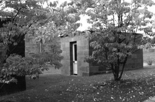 View of the exterior of Building 30, showing its small, rectangular, single-storey form, 1991.; Parks Canada Agency / Agence Parcs Canada, Rhona Goodspeed, 1991.