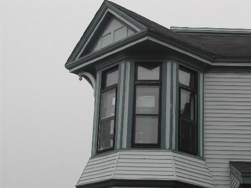 This photograph shows the irregular placement of the bay with multiple windows and crowned by a pediment, 2005; City of Saint John