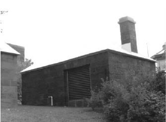 View of Building 29, showing the thick stone walls and chimney, 1992.; Agence Parcs Canada / Parks Canada Agency, R. Goodspeed, 1992.