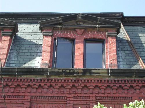This photograph shows the pedimented  dormers and the elaborate brick detail at the cornice, 2005; City of Saint John