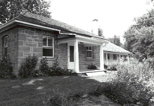 Façade of the Defensible Lockmaster's House, showing the simple, square, single-storey massing, 1989.; Parks Canada Agency / Agence Parcs Canada, Couture, 1989.