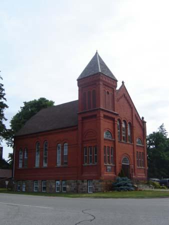 Of note is the three-storey bell tower and steep cone-shaped roof.; Martina Braunstein, 2007.