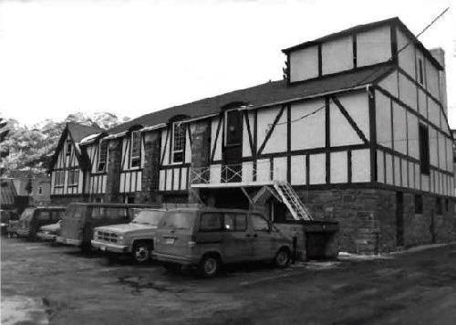 Rear view of the Information Building, showing its two-storey, rectangular plan with cross-gable roof, 1991.; Parks Canada Agency / Agence Parcs Canada, C. Wittig, 1991.