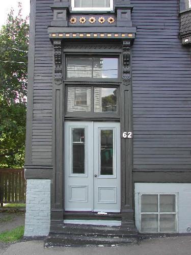This photograph shows the entrance of the home with bracketed entablature and transom windows, 2005; City of Saint John