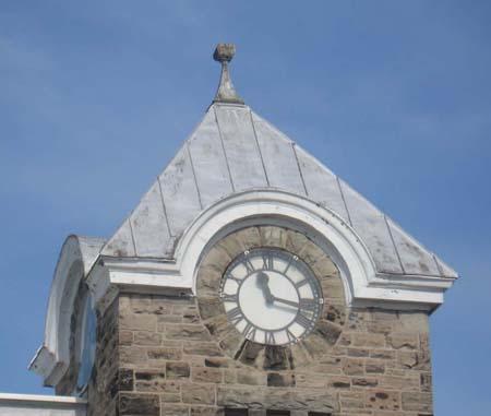 This photo features round clock faces capped by eaves eyebrows, 2007.; Kayla Jonas, 2007.
