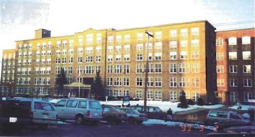 Façade of the Gulf Fisheries Centre, showing the planar quality of the simple façade of local limestone with minimal decoration, 1993.; Department of Fisheries and Oceans / Ministère des Pêches et des Océans, 1993.