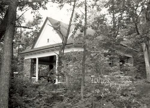 Corner view of the the West Grenadier Island Pavilion, showing the large, gabled dormers clad in clapboard siding, 1992.; Parks Canada Agency / Agence Parcs Canada, 1992.