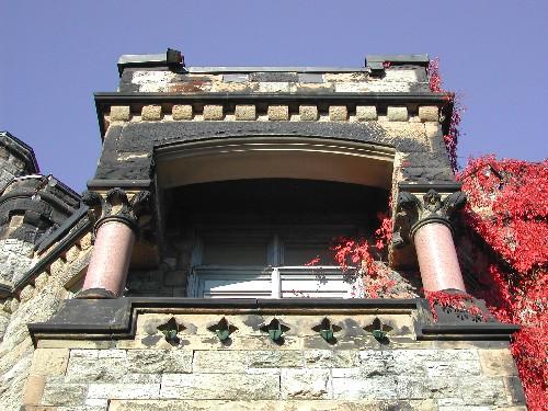 This photograph shows the handsome balcony, the red granite columns and the carved quatrefoils, 2005; City of Saint John