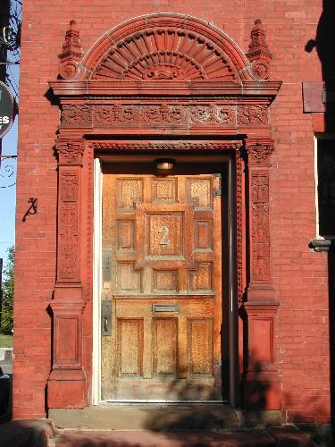 This photograph shows the main entrance with pilasters, entablature frieze and segmented pediment, 2005; City of Saint John